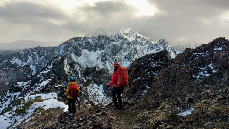 Image: Two hikers trek down the Buckhorn Mountain Trail in the Olympic National Park. Photo by Grant Roush.
