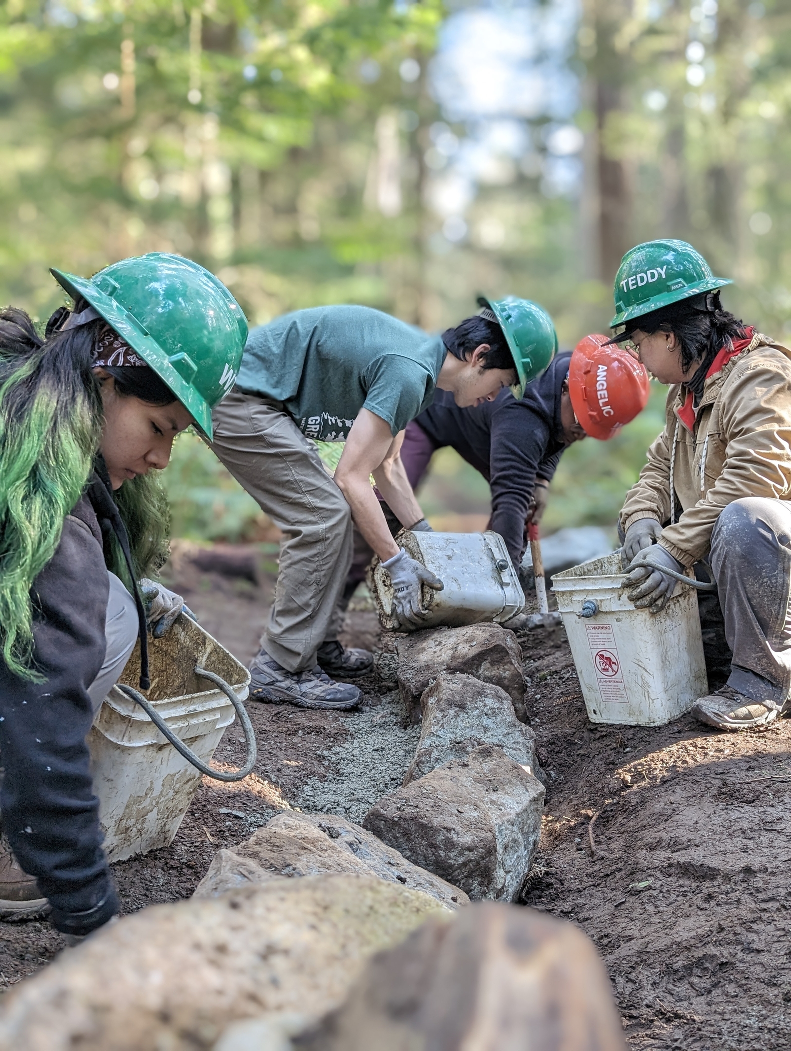 Crew filling in gravel on a trail. Photo by Tiffany Chou