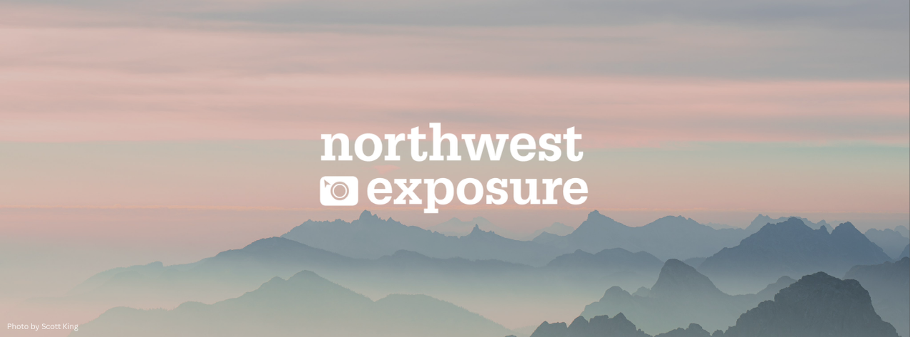NWX 2026. Photo by Scott King. Light pink and blue foggy dusk of sunset/rise over sharp mountain peaks.