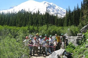 WTA volunteers cut the ribbon on July 31, 2011 - the 151st and final day of work on the Glacier Basin Trail. Photo by Lynn Kittridge.