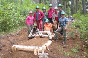 High school students working together as part of a WTA Youth Vacation pose next to their completed turnpike on the PCT north of Deception Pass. Photo by Steve Hertzfeld.