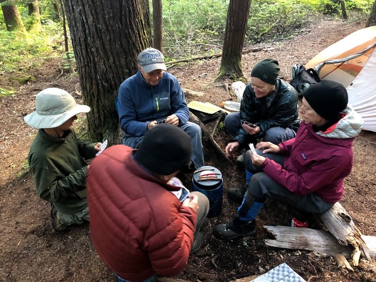 Volunteers play cards at camp after a long day of trail work. Photo by Emily Snyder. 