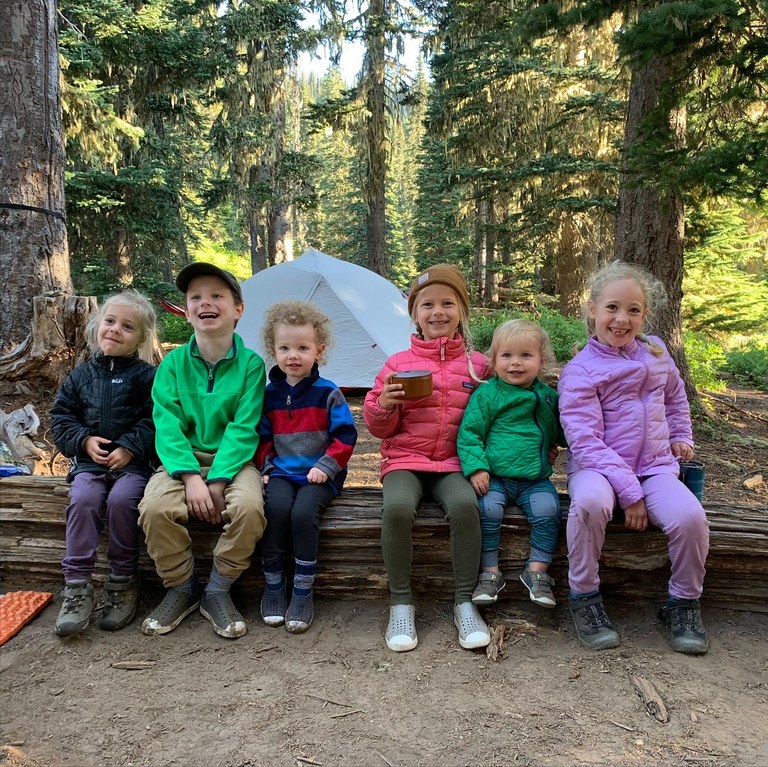 Smiling kids line up for a photo. 