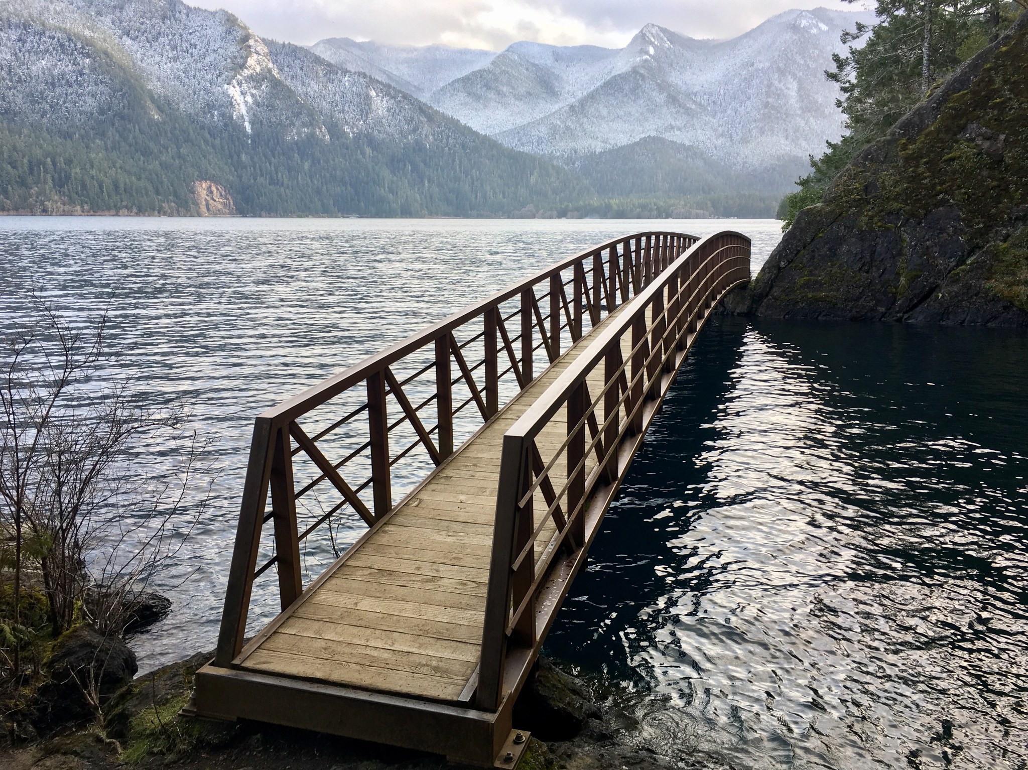 A bridge crosses a glaciated lake