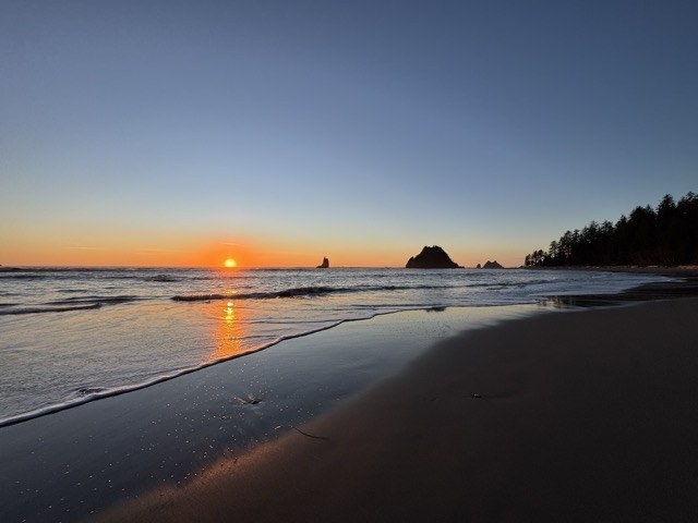 sunset on the washington coast An orange sun sets below the Pacific Ocean near Toleak Point