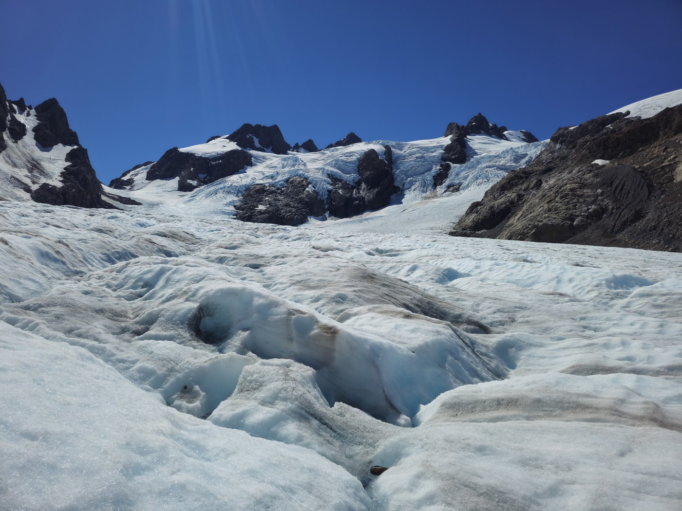 A snowy glacier with rocks.