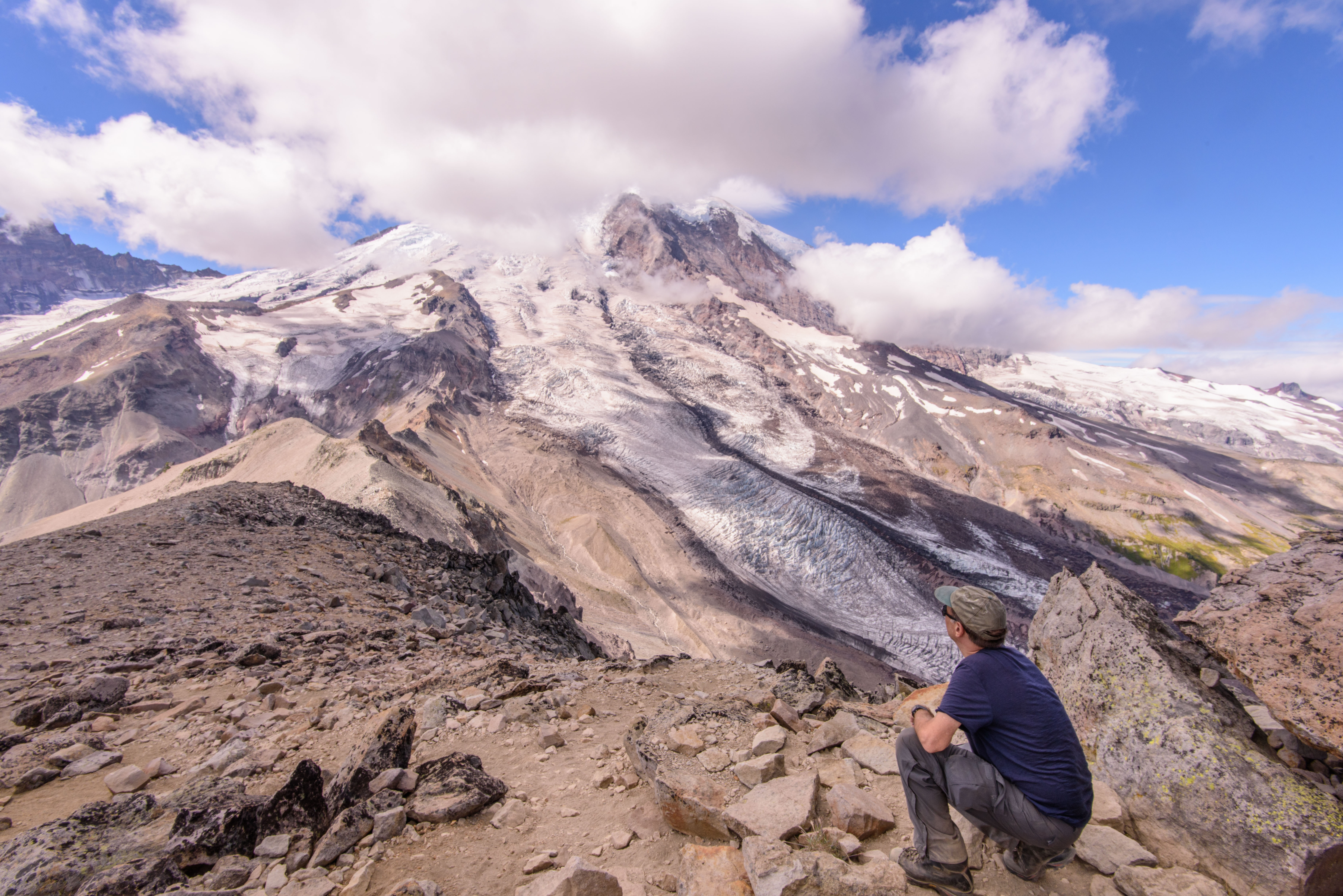A hiker admires Mount Rainier from Burroughs Mountain.