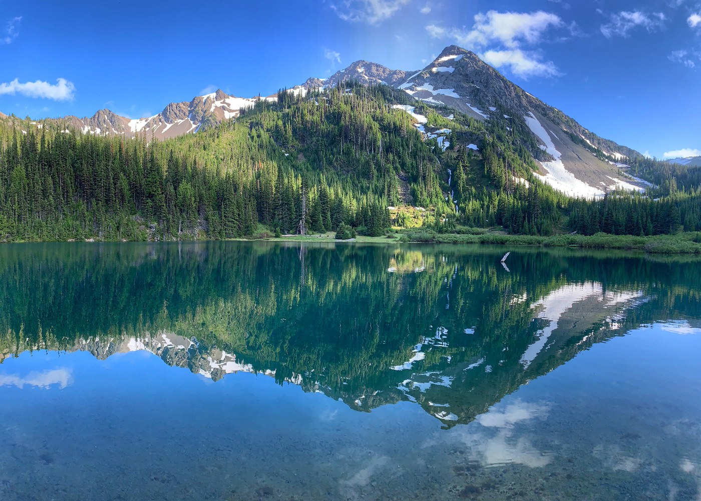 Alpine lake with mountain in background.