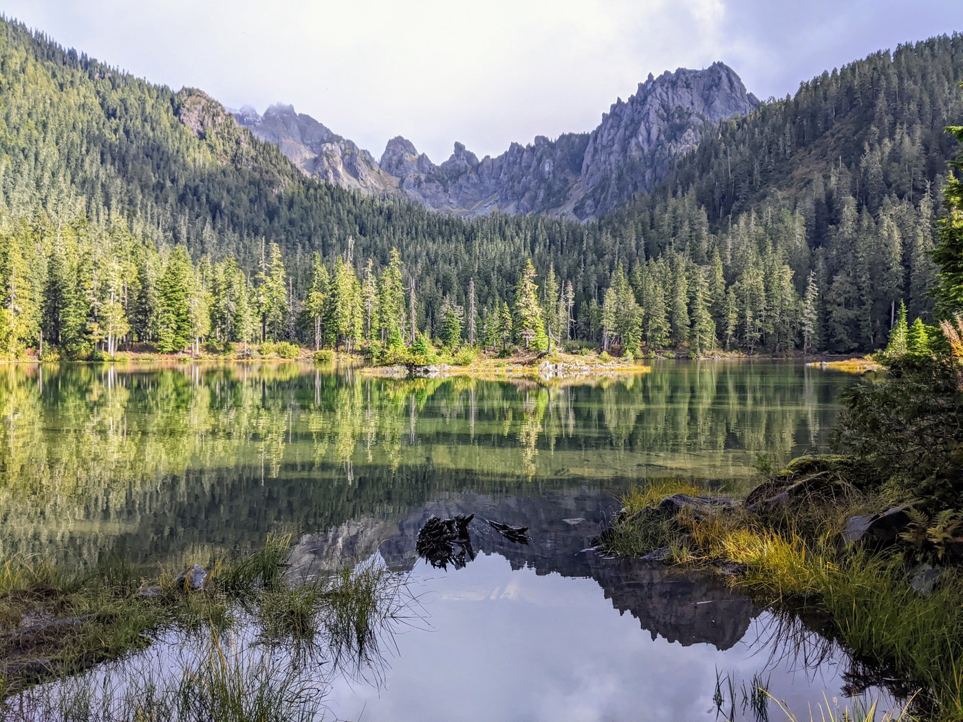 A aquamarine lake ringed by trees and rocks.