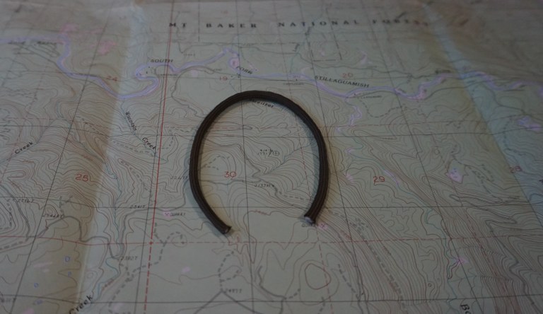 A horseshoe shape on a hiking map. 
