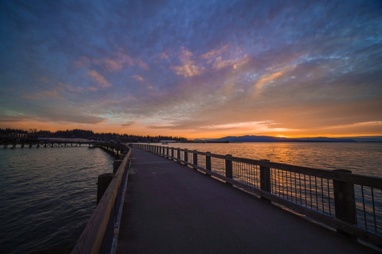 Pier stretching into bellingham Bay at sunset along the South Bay Trail. Photo by brittanywanderlust.