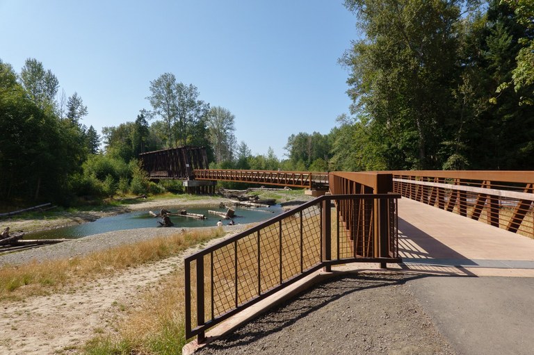 A wide bridge extends across a river. 