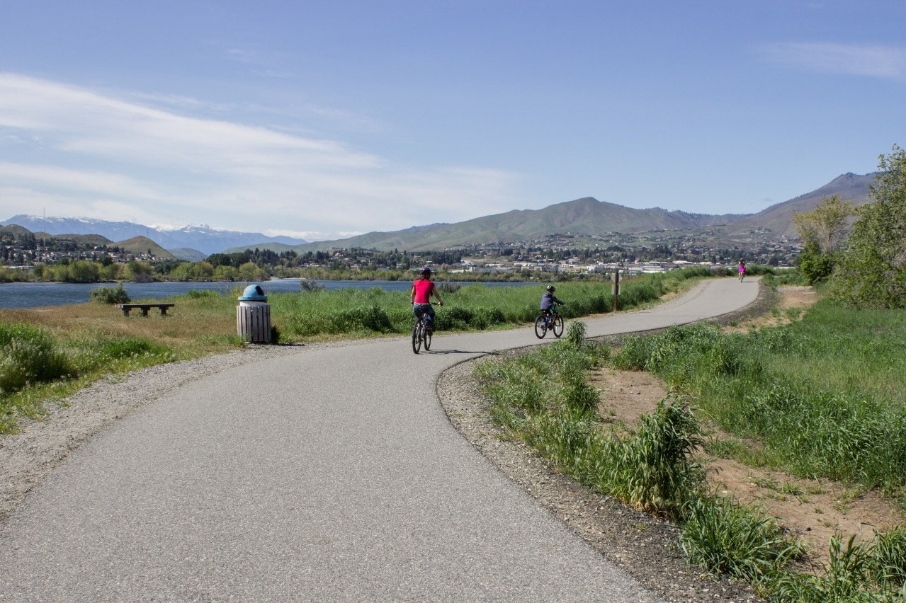 Hiker and bikers on Apple Capital Recreation Loop Trail by Ken Peterson