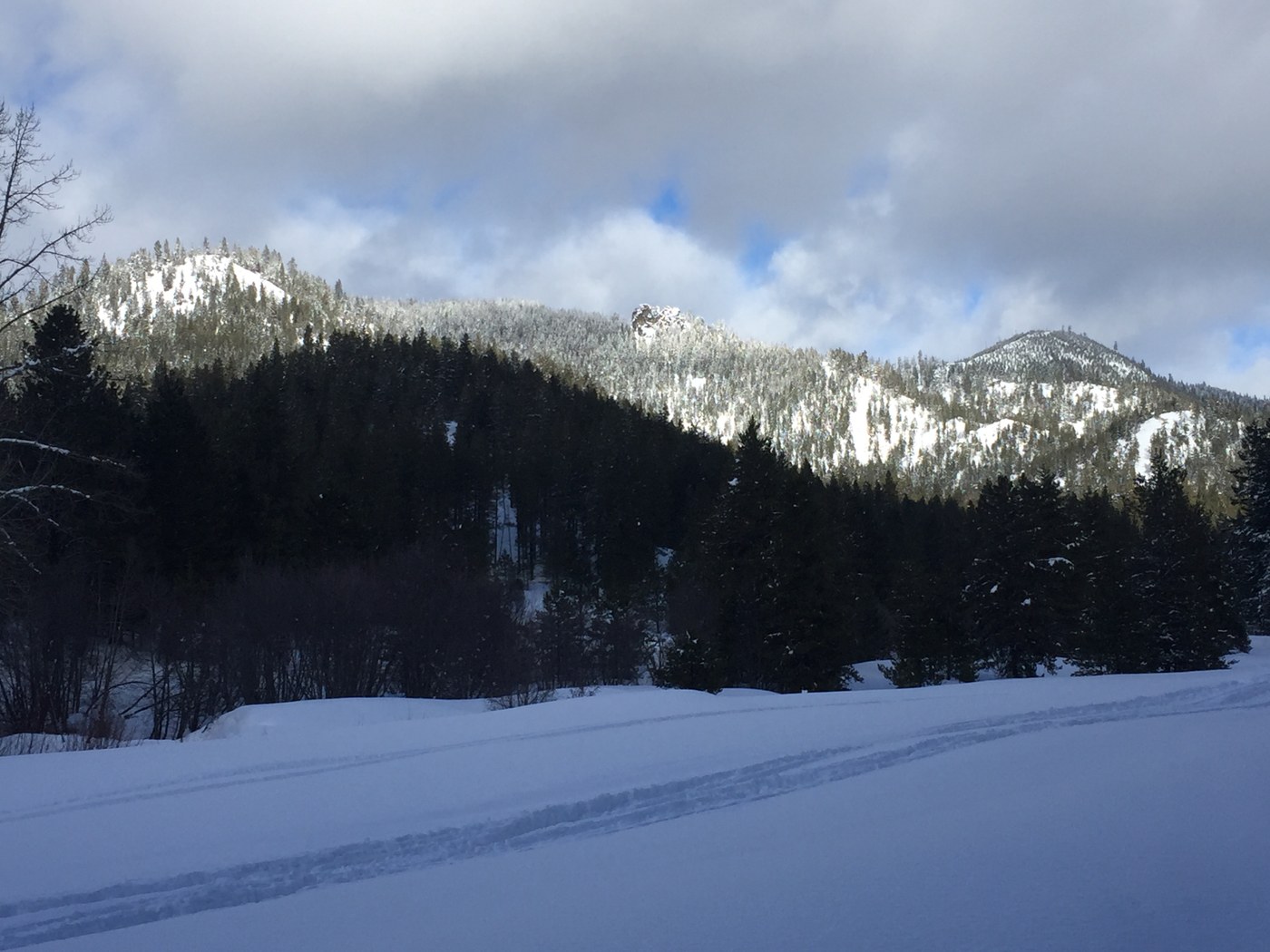 Hurley Road Snowshoe. cascadesdj. A road covered in deep snow looking out at forested hills.