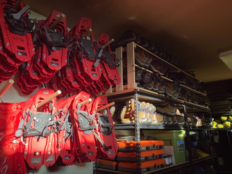 WTA snowshoes hang against a wall.