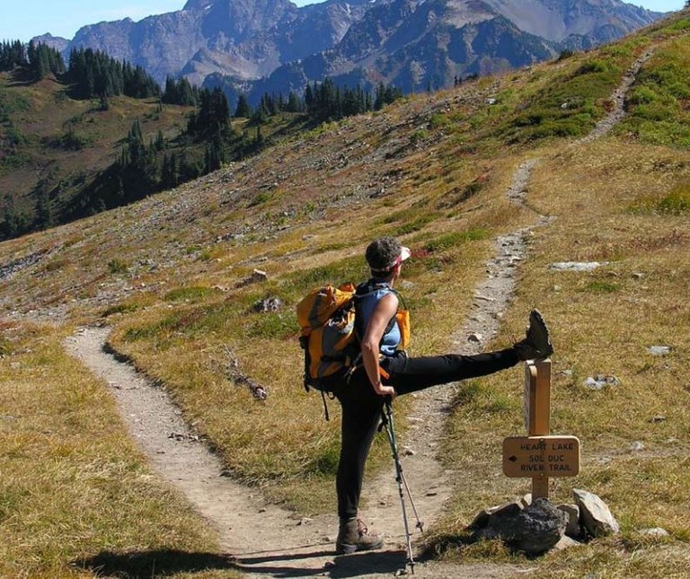 Hiker Sherri Cassutto takes a stretching break on the High Divide Trail in the Olympics. By working on strenght, endurance, flexiblity and balance, you’ll make your time on trail more enjoyable.