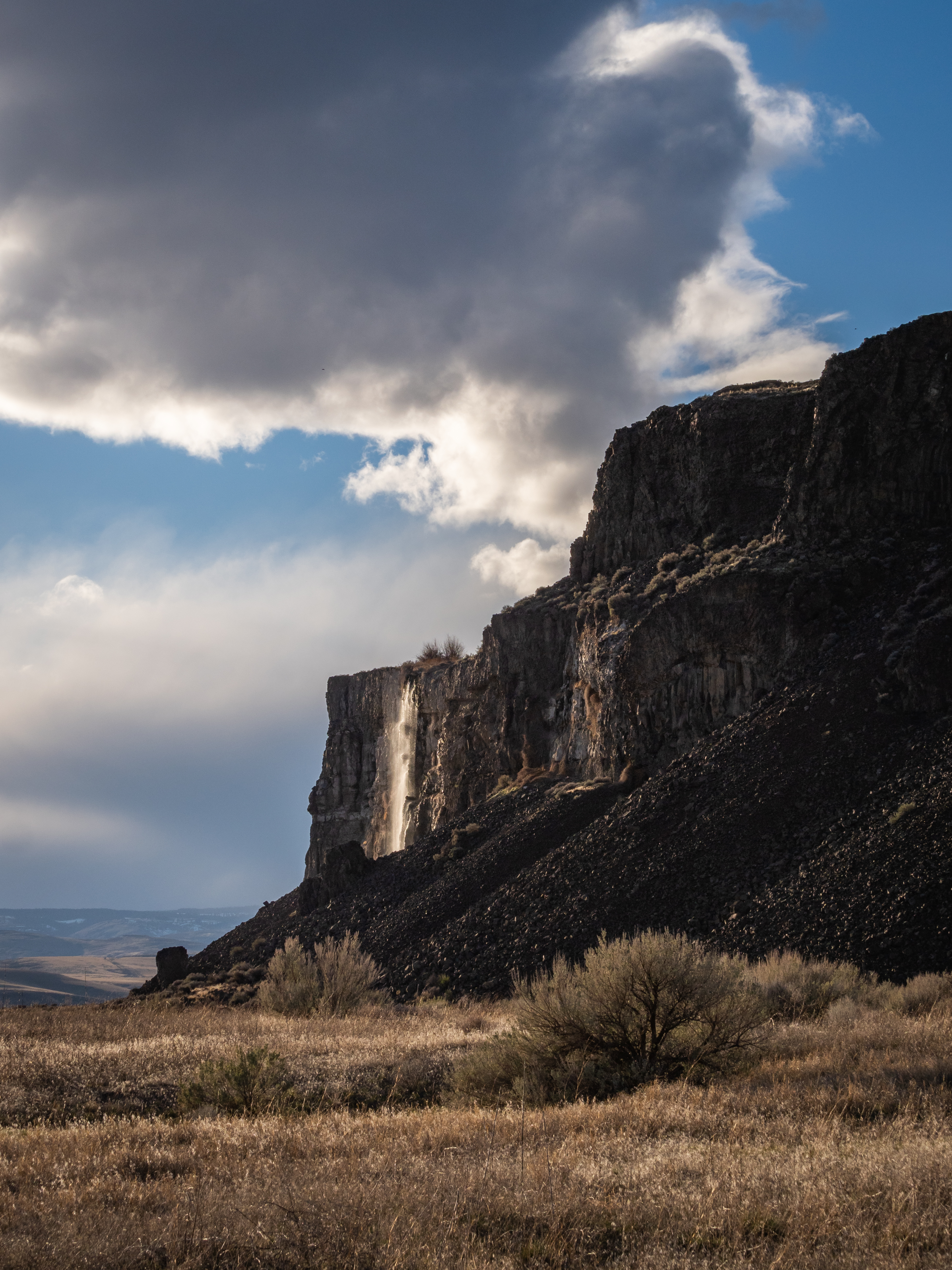 Waterfall An illuminated waterfall cascading down a rocky cliff.