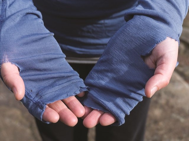A worn out hiking shirt with thumb holes.
