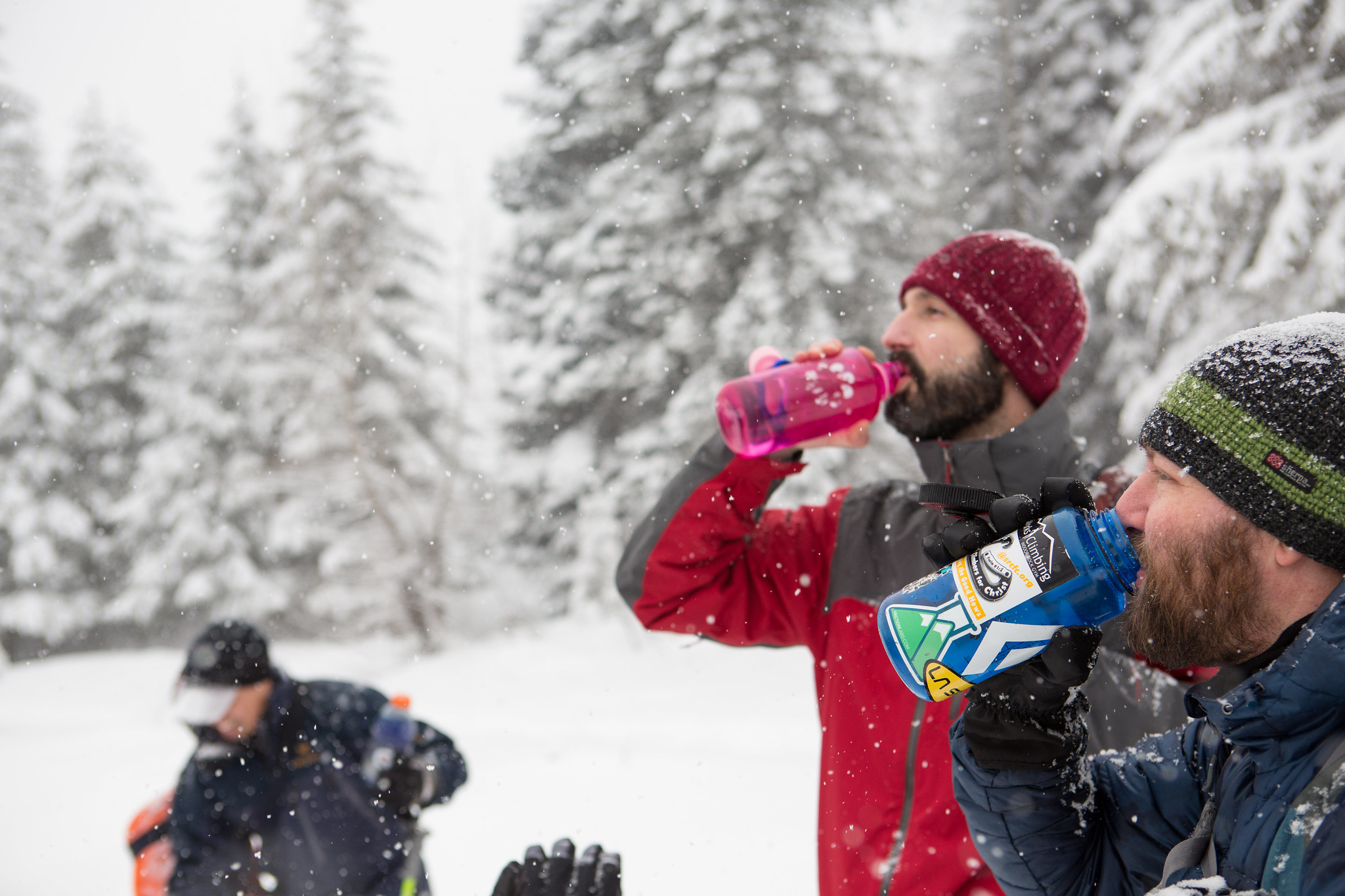 Participants in an Outdoor Leadership Training snowshoeing course stop for water. Photo by Emma Cassidy.