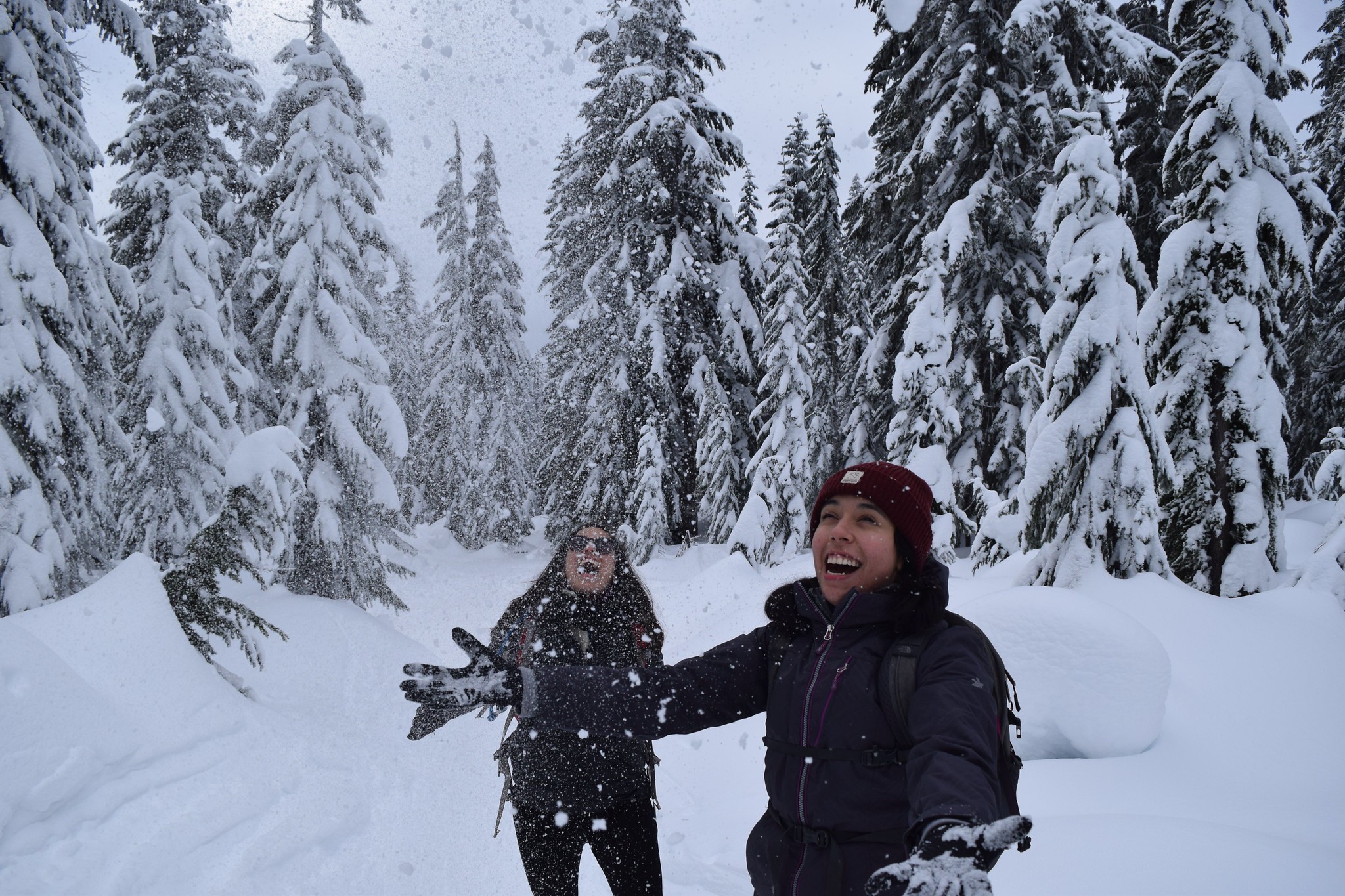 Two hikers having fun throwing snow in the air on the Skyline Lake trail. Photo by Iris Zacarias.