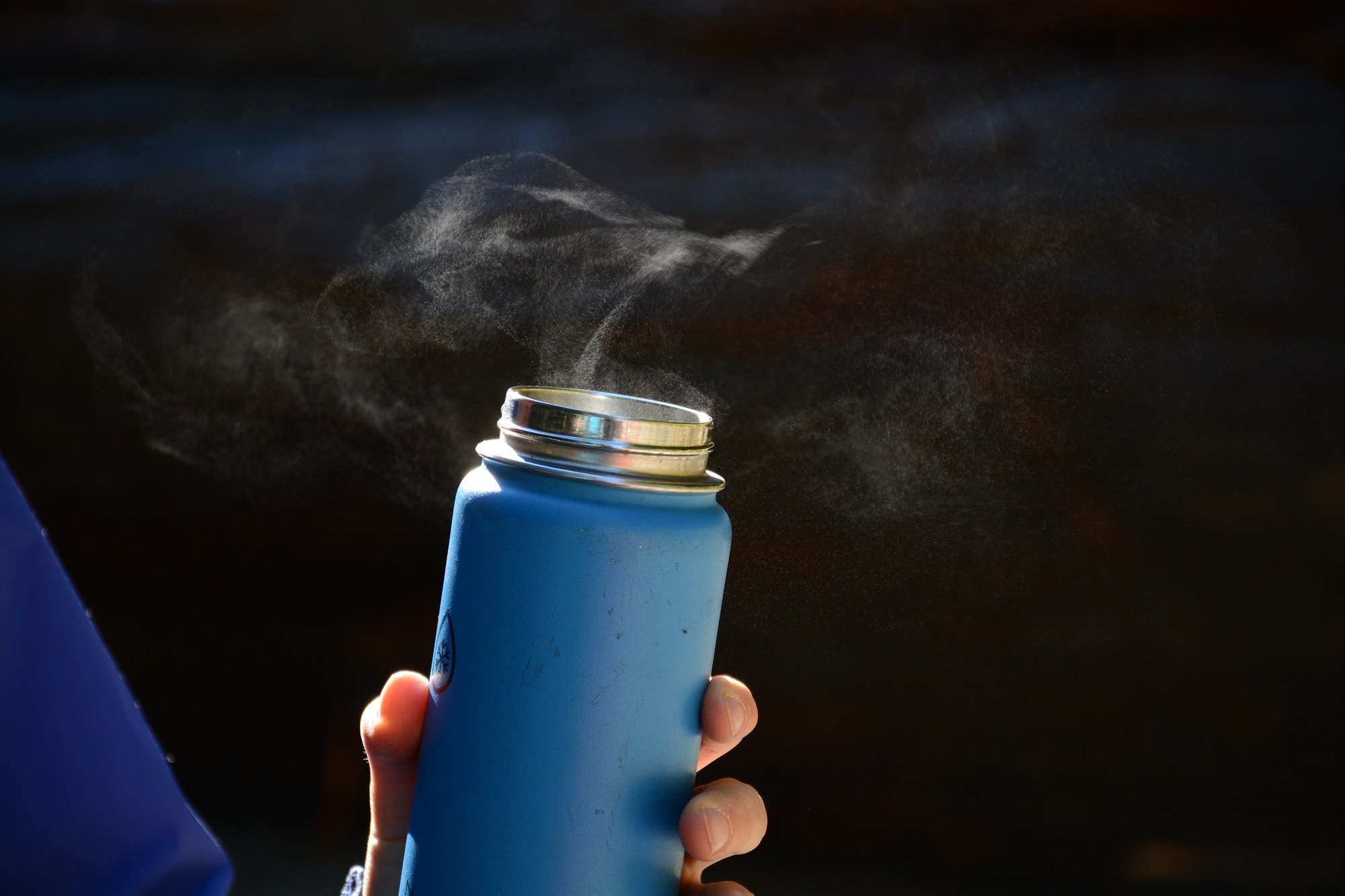 Steaming thermos An open thermos lets off steam during a brisk winter hike.