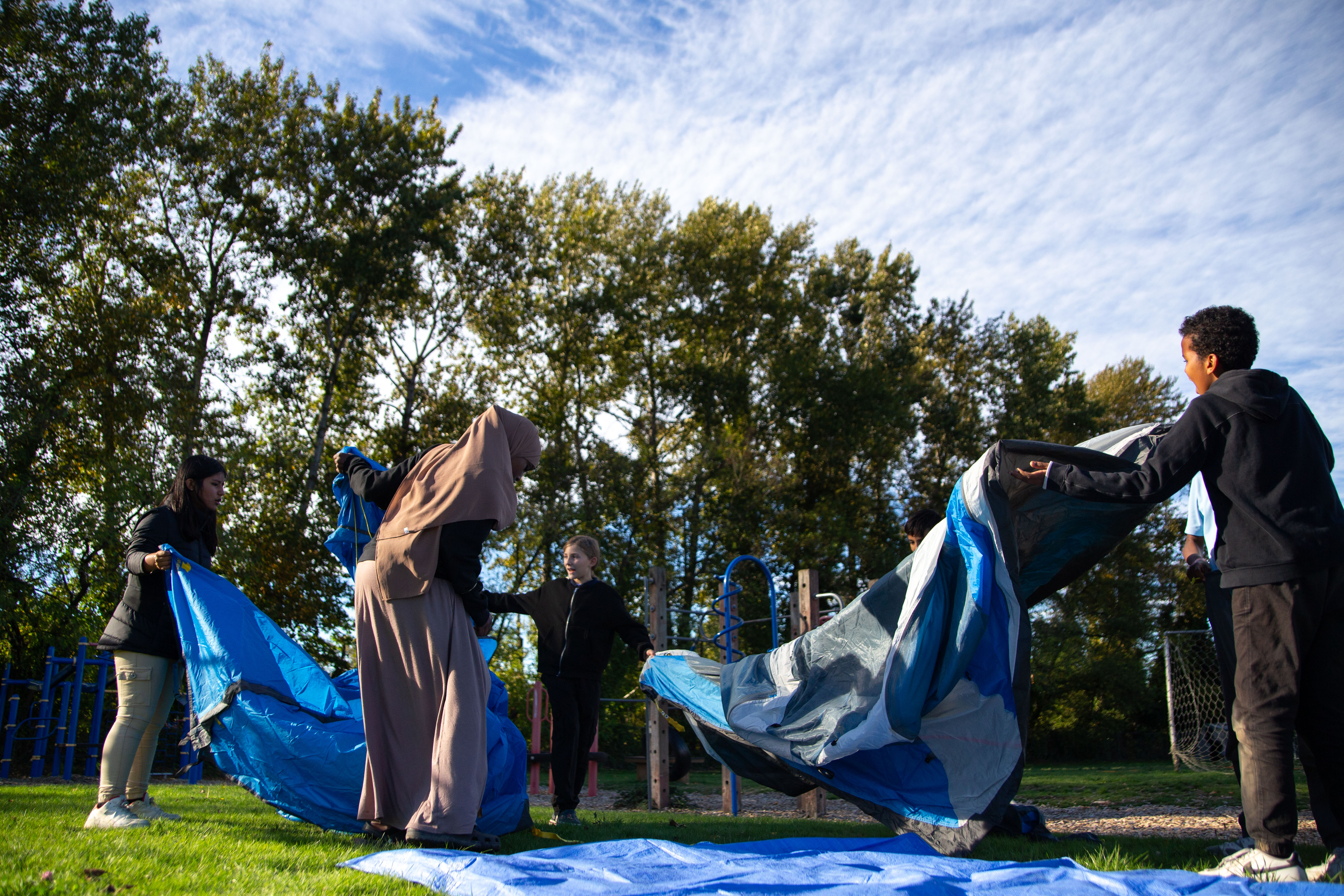 Students practice setting up tents before their outing