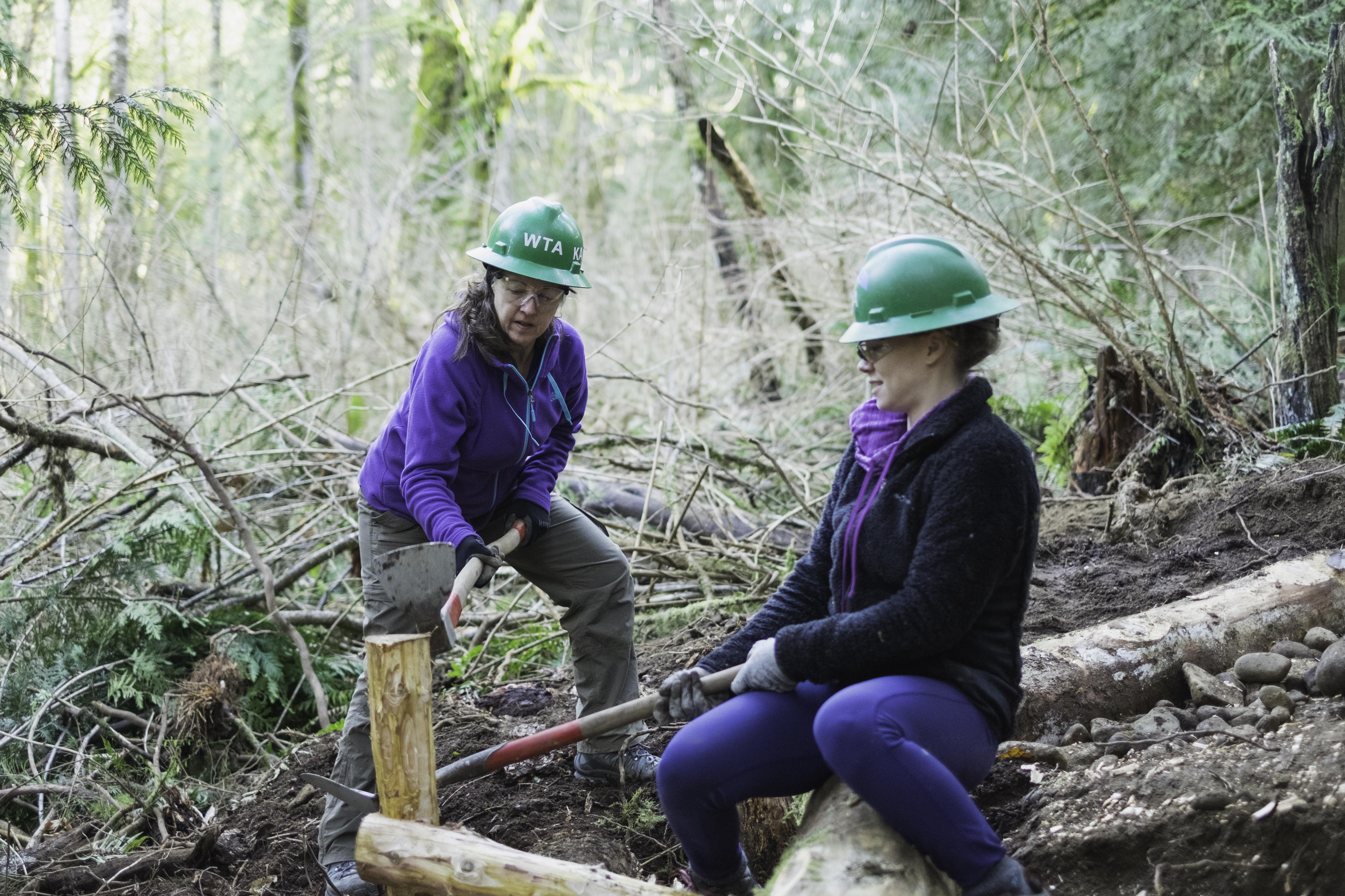 Volunteers work on a crib wall