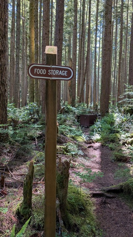 Sign reads "Food storage" with bear locker in the background.