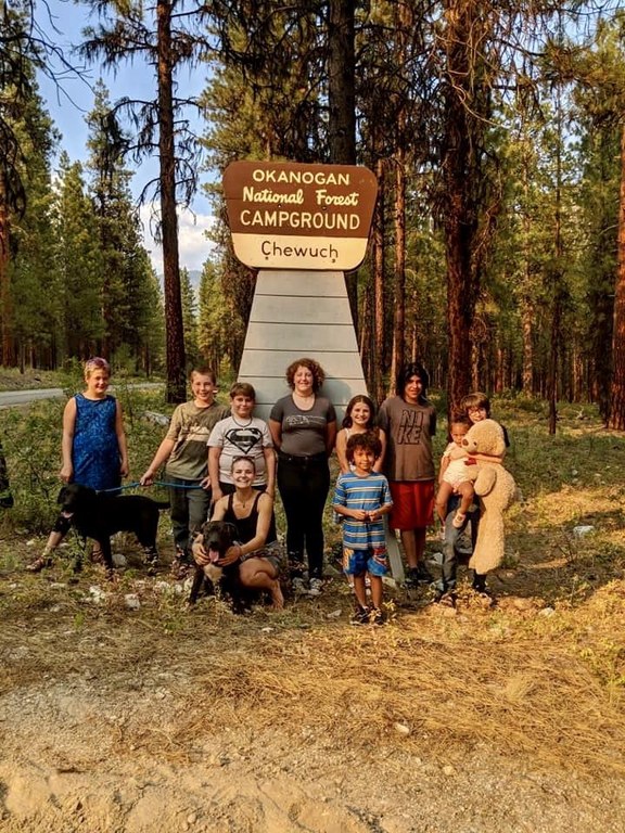 The Cramers A large group of people stand in front of the Chewuch Campground sign.