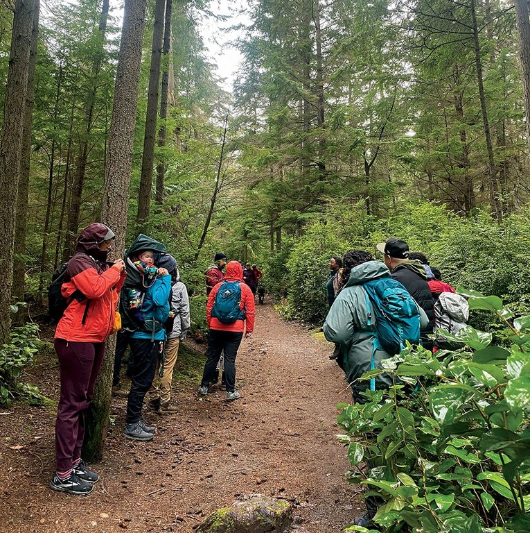 The ELP cohort and community partners hike on a rainy day.