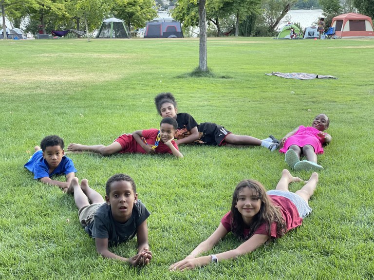 Six kids hang out on the grass during a Bronze Chapter event held in Eastern WA.