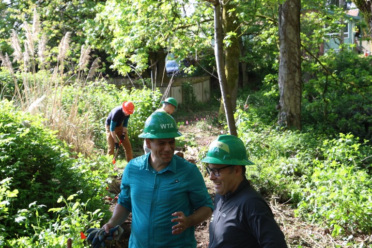WTA CEO Jaime Loucky and King County Parks Director Warren Jimenez at a work party at Glendale Forest on Earth Day 2024. Photo by Victoria Obermeyer. WTA CEO Jaime Loucky and King County Parks Director Warren Jimenez chat with one another at a WTA work party.