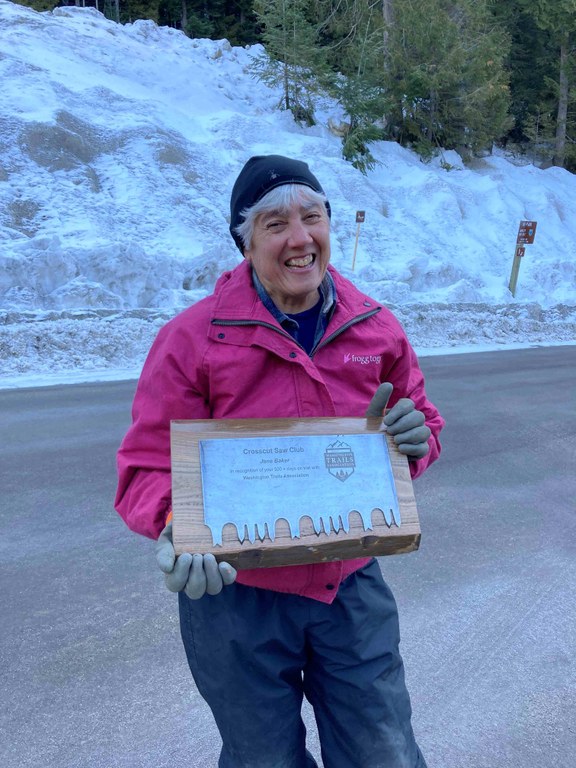 Jane Baker with a Crosscut Saw Club plaque for completing 500 days on trail with WTA. Photo by Holly Weiler.