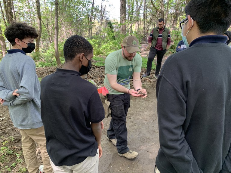 Rainier Prep students joined WTA Youth trail coordinator Kaci Darsow to learn about soil ecology and trail work at Glendale Forest in 2022. Youth and a WTA employee chat trails.