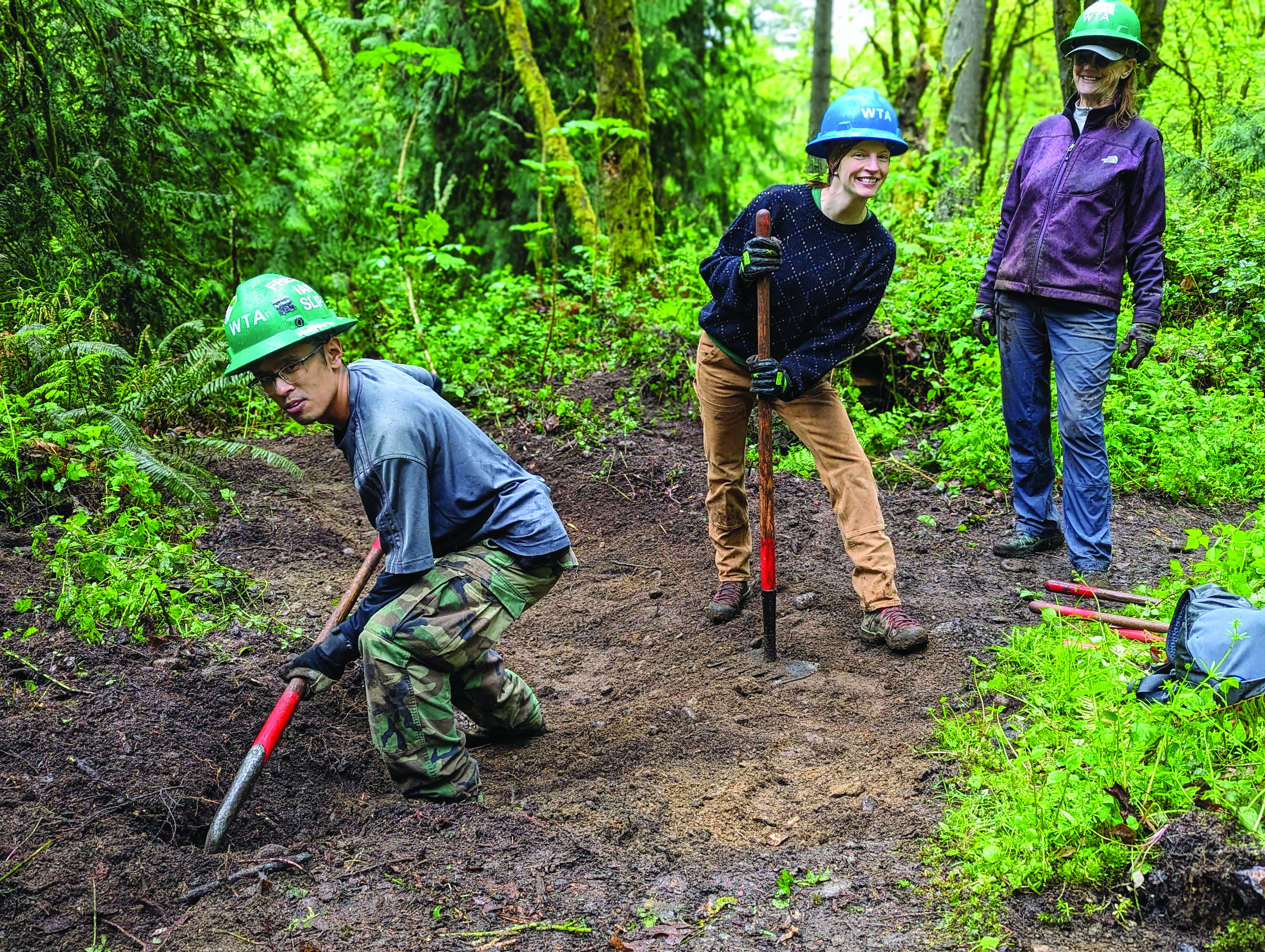 liza cougar mtn work party by Bob Zimmerman.jpg Crew smiling on trail holding trail tools.