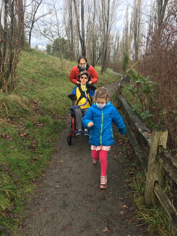 Three hikers amble down an accessible trail.