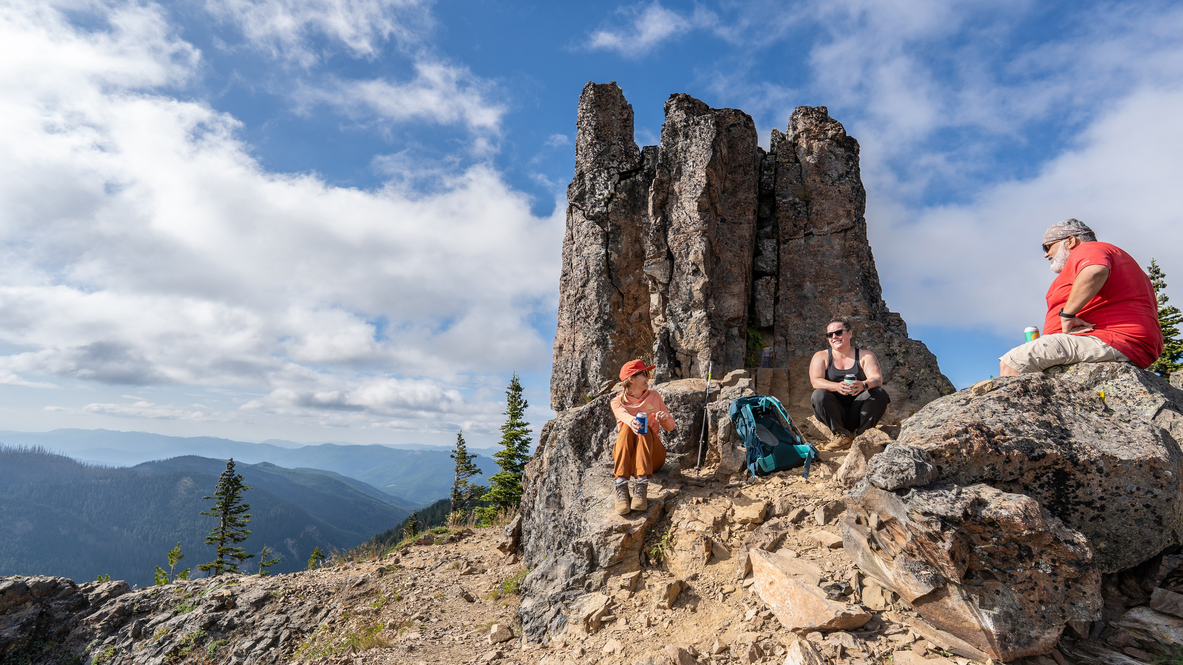 Photo of hikers resting on exposed, rocky section of Noble Knob