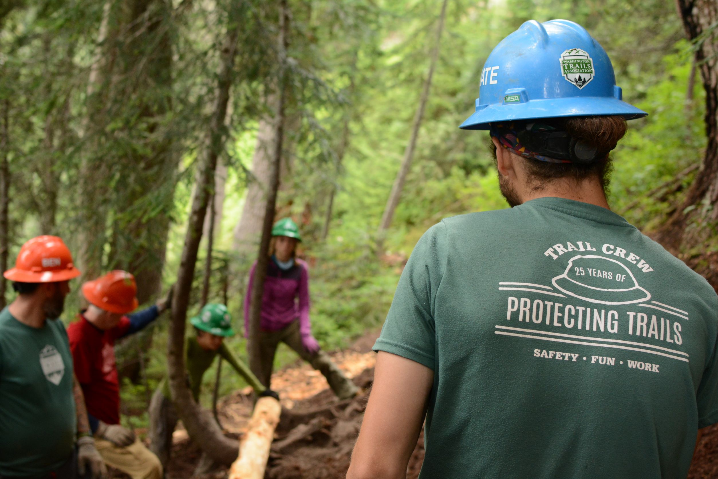 A WTA crew leader keeps an eye on volunteers during a trip to Blanca Lake.