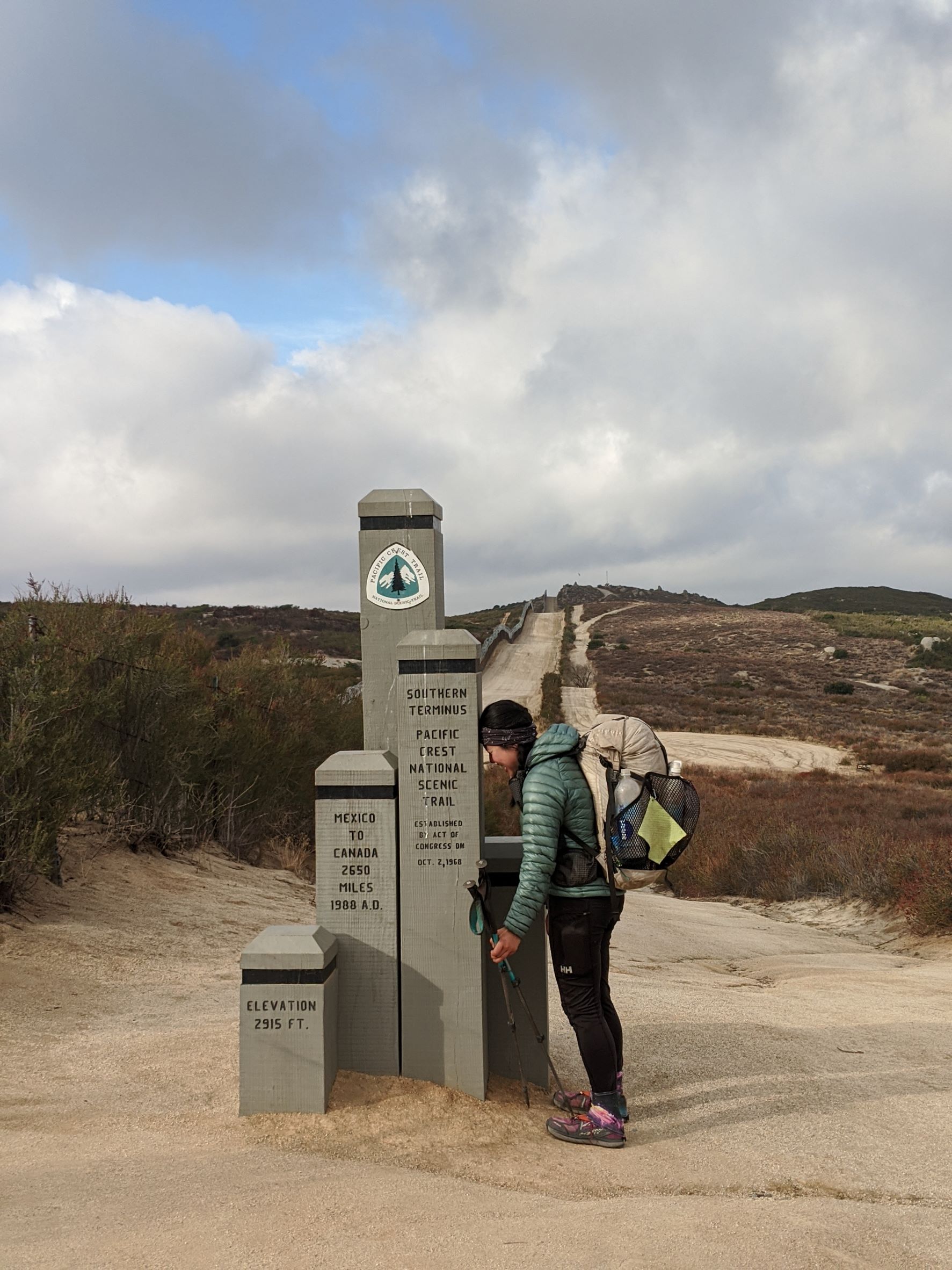 Tiffany at the Pacific Crest Trail southern terminus monument after completing a southbound thru-hike. Photo by Tiffany Chou.