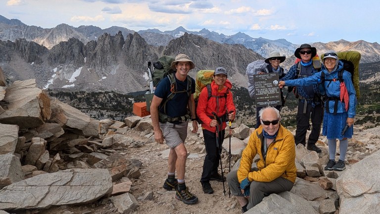 A group of hikers in the Sierra on a pass.