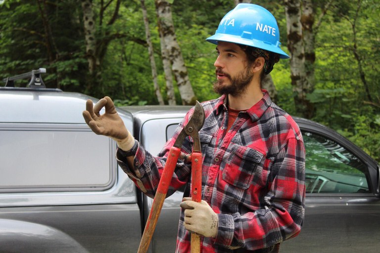 A blue hat holds a pair of sheers.