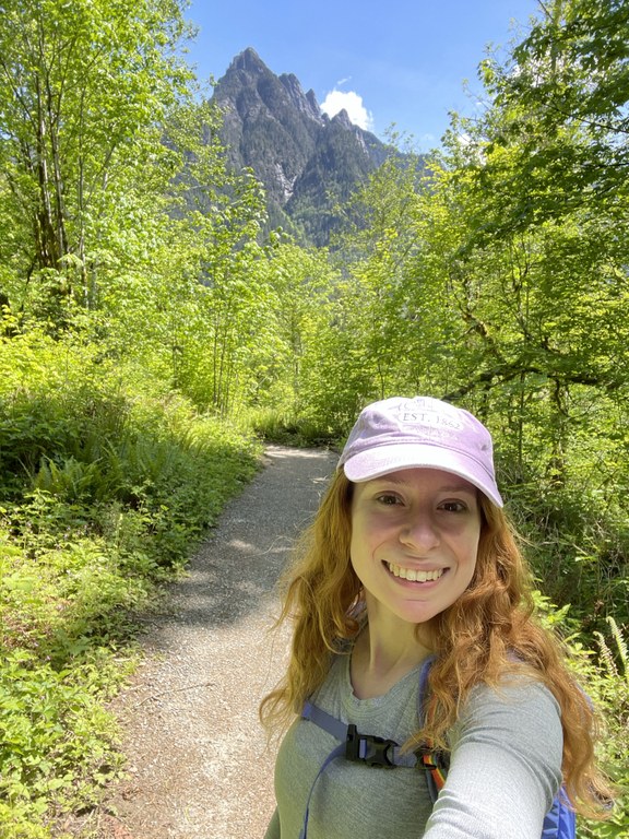Selfie at Oxbow. Photo by McKenna Princing. Women smiling on trail with mountain in background.