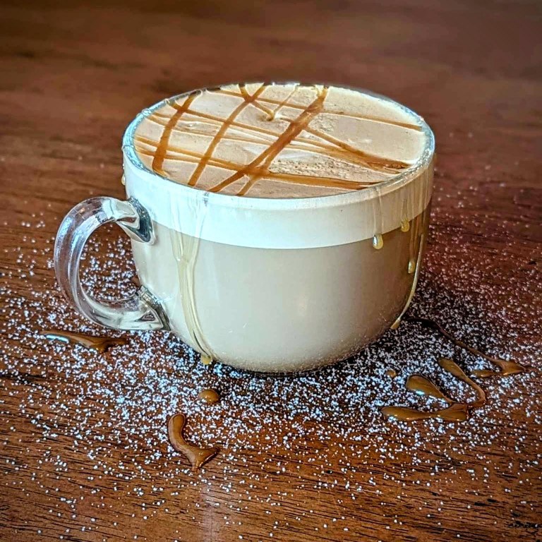 Looking for high quality hot beverages in Southwest Washington? Cafe Guse is your spot. Photo courtesy of Cafe Guse A decadent warm drink with foam, caramel drizzle and powdered sugar.