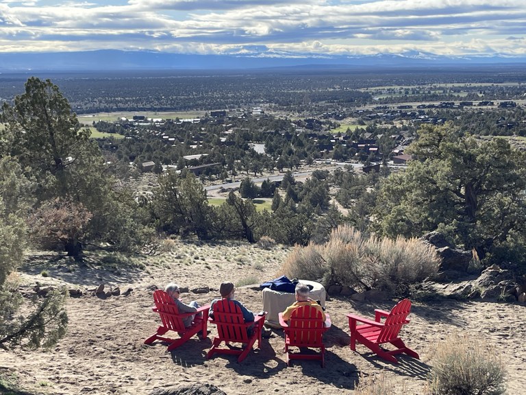 Spirit Rock A group of people sit in lawn chairs and look out over a desert view.