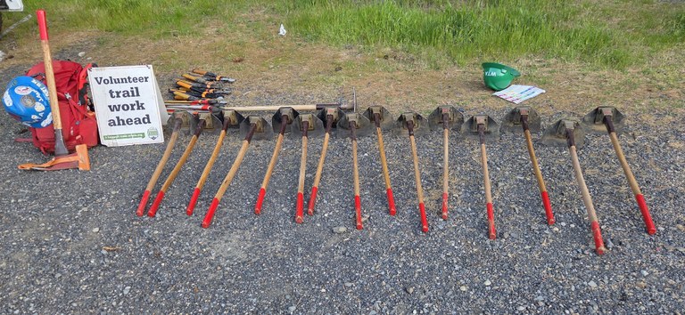 A collection of WTA tools and a trail sign.