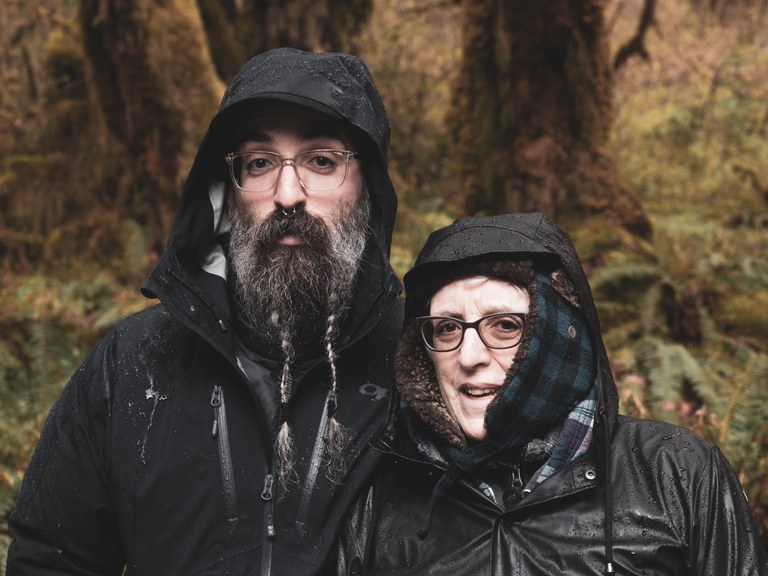two hikers in the rain wearing coats
