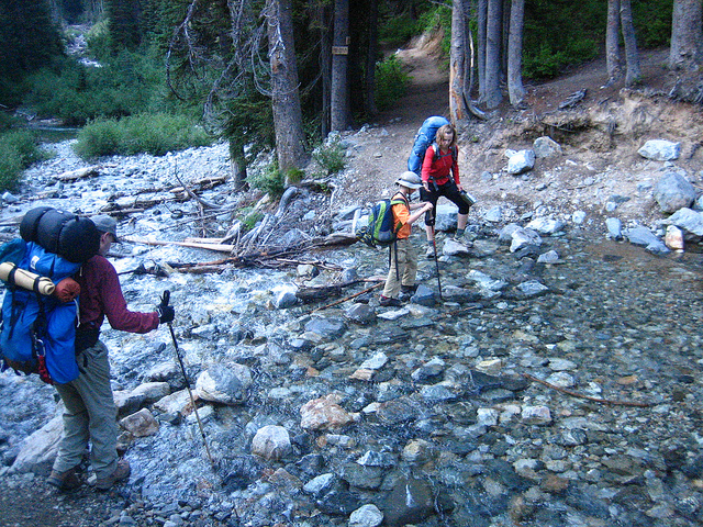 Take your time at water crossings. Here, three generations navigate Leroy Creek (very gingerly). Photo by Andrew Snoey