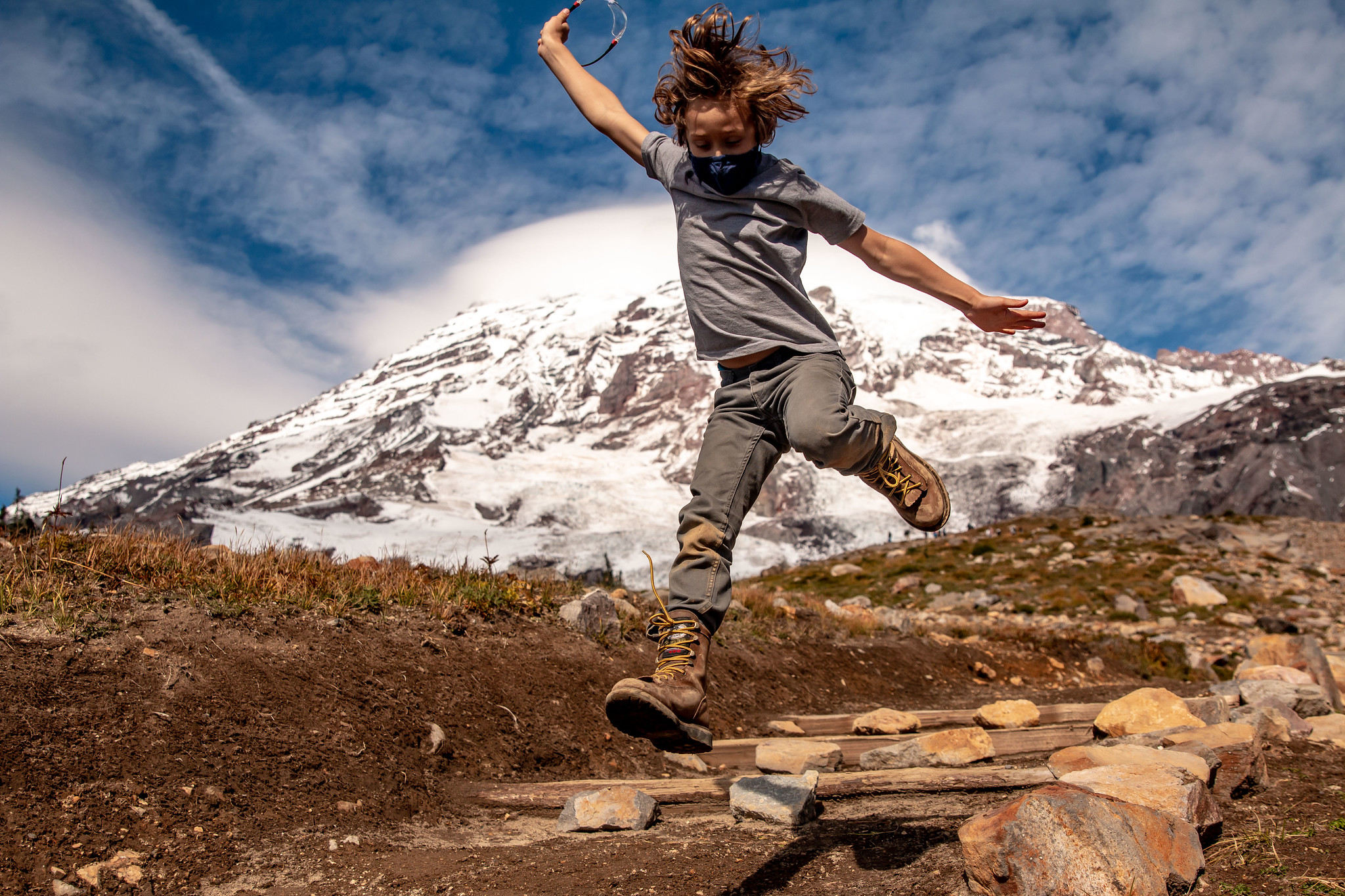 Photo by Nikki Womac Boy jumping in front of Mount Rainier