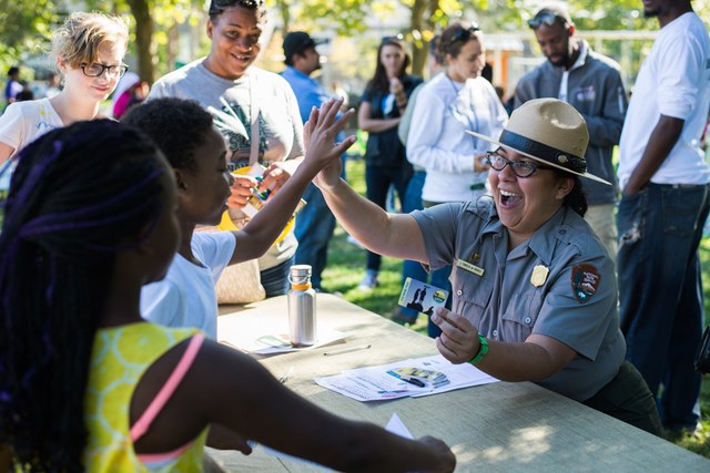 A National Park Ranger high-fives fourth graders at an Every Kid in a Park event. Photo by Erik Haugen-Goodman
