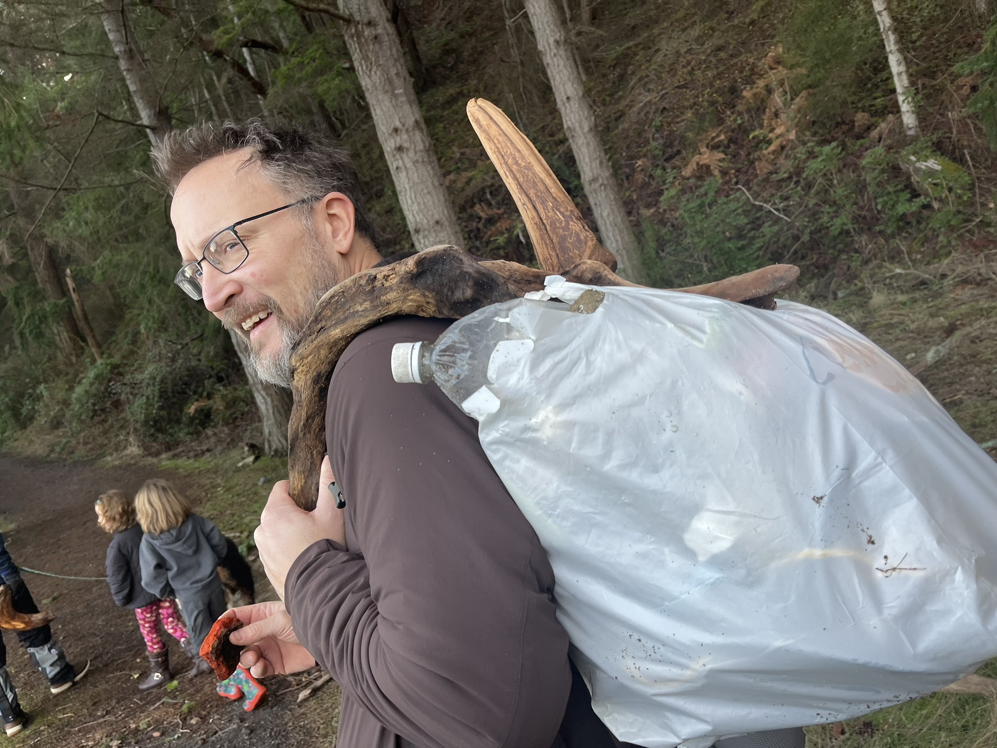 Man with a bag of garbage he picked up on the beach. Barnum Point. Photo by TrailMomma.